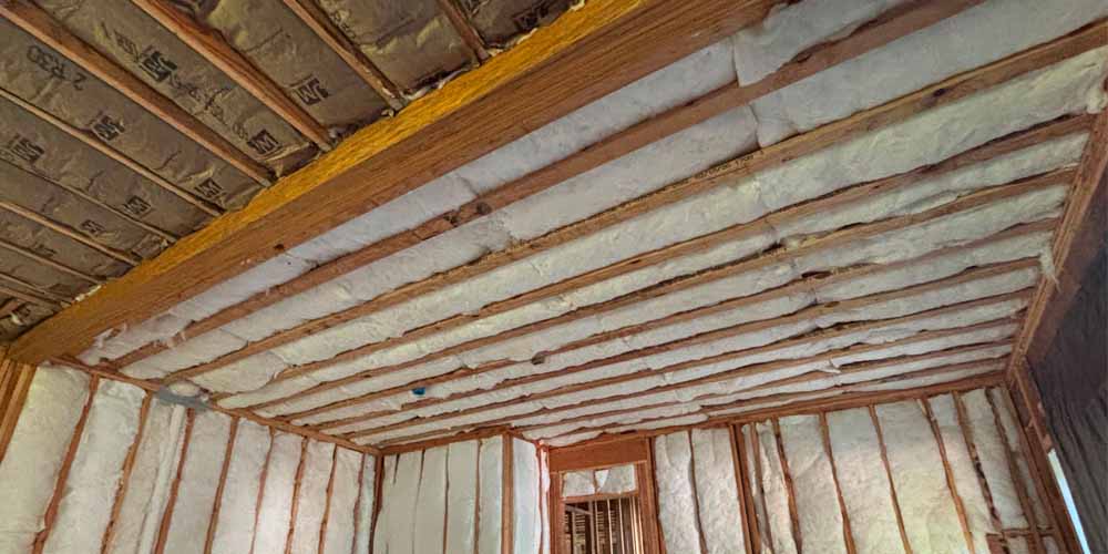 Choose Efficient Insulation for Your Project – Hudson Insulati Closed-cell spray foam insulation applied to wall studs and ceiling joists in a single-family home in Brick, NJ, by Hudson Insulation.