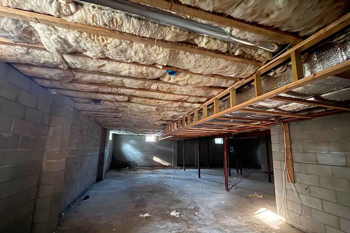 Spray foam insulation applied to crawl space ceiling with radiant barrier decking, single-family home in Brick, NJ, by Hudson Insulation.